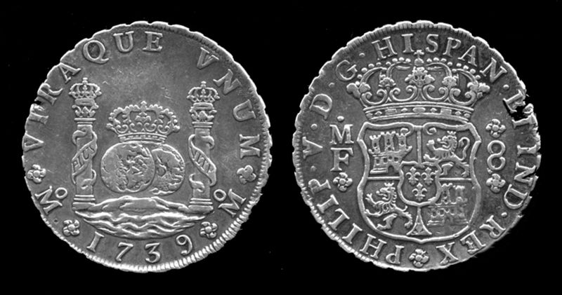 A Spanish colonial silver coin of the kind that washes up on Florida beaches